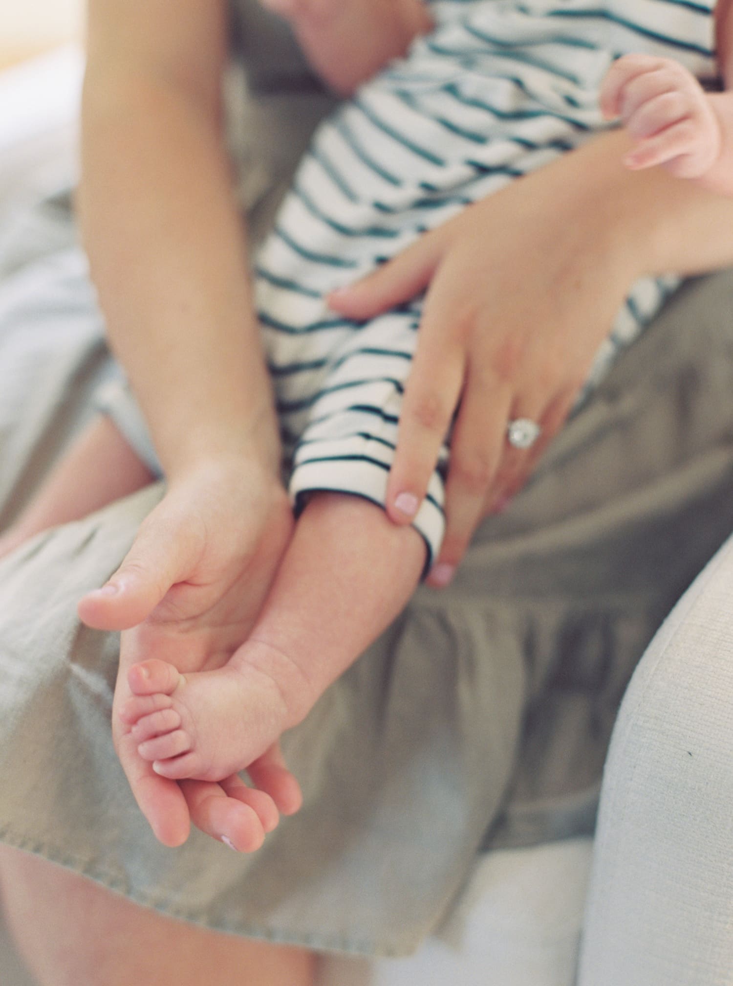 Up close photo for a mother holding her child's toes