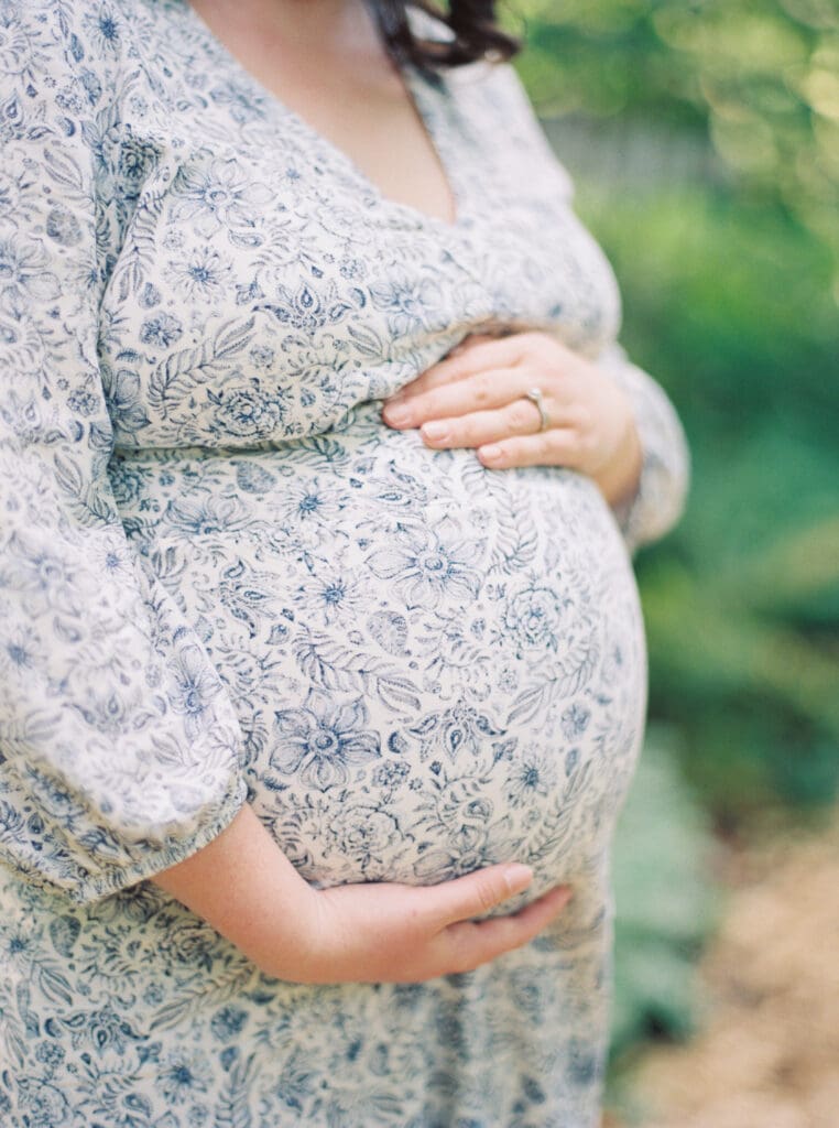 Maternity session at Brookside Gardens — expecting mother walking hand in hand with her husband, captured by luxury maternity & newborn photographer Washington DC area.
