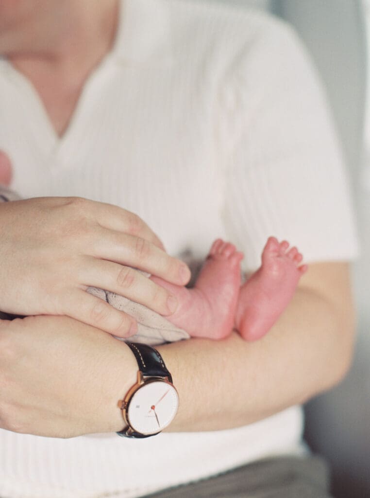 Mother holding her newborn baby boy during an in-home session in Washington DC — intimate lifestyle photos by luxury maternity & newborn photographer Washington DC area