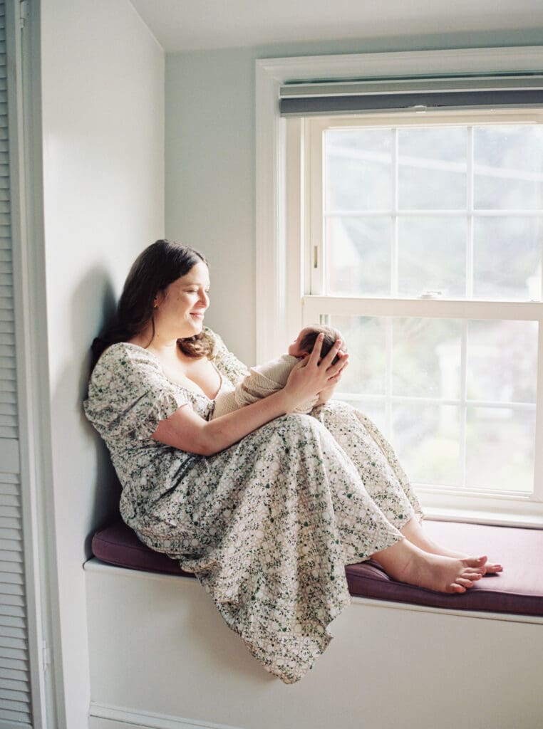Mother holding her newborn baby boy during an in-home session in Washington DC — intimate lifestyle photos by luxury maternity & newborn photographer Washington DC area