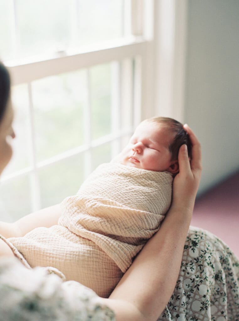 Mother holding her newborn baby boy during an in-home session in Washington DC — intimate lifestyle photos by luxury maternity & newborn photographer Washington DC area