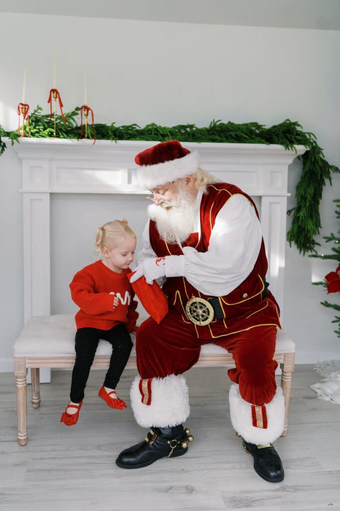 Little girl sharing Christmas wishes with Santa in Baltimore